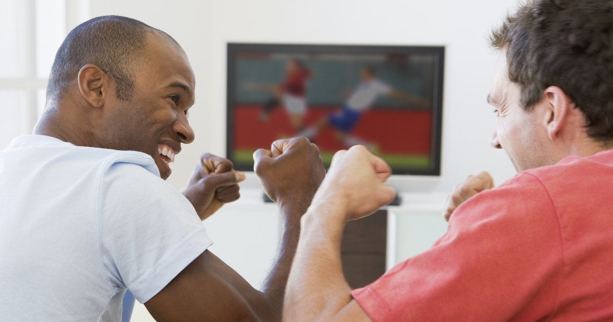 https://www.mediavillage.com/media/articles/two-men-in-living-room-watching-television-and-cheering_St7FZ20Bs.jpg.1200x630_q85_box-0%2c250%2c4992%2c2870_crop.jpg